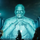 A large holographic image of Shinra's CEO from FF7 Remake.